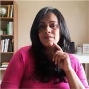 Warm, professional tutor teaching English basics to business. 