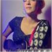 Female guitar tutor teaching guitar to students of all ages and expertise