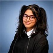 Supportive A-Level student helping younger learners achieve success