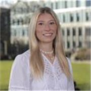 Patient psychology student supporting children’s learning and confidence.
