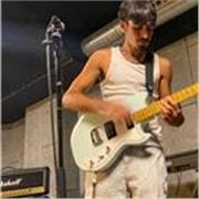 Guitar tutor with RGT Grade 8 certification and Musicology degree, offering inspiring private and online guitar lessons