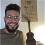 start with simple chords (like G, C, D), practice scales for finger dexterity, and learn to read tabs for easy note reference