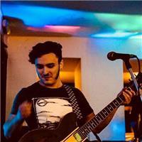 Friendly and personable tutor teaching bass guitar, drum-kit and voice